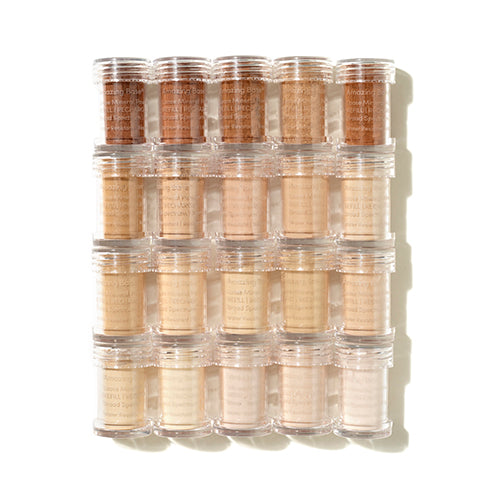Set of makeup foundation tubes in various shades on a white background