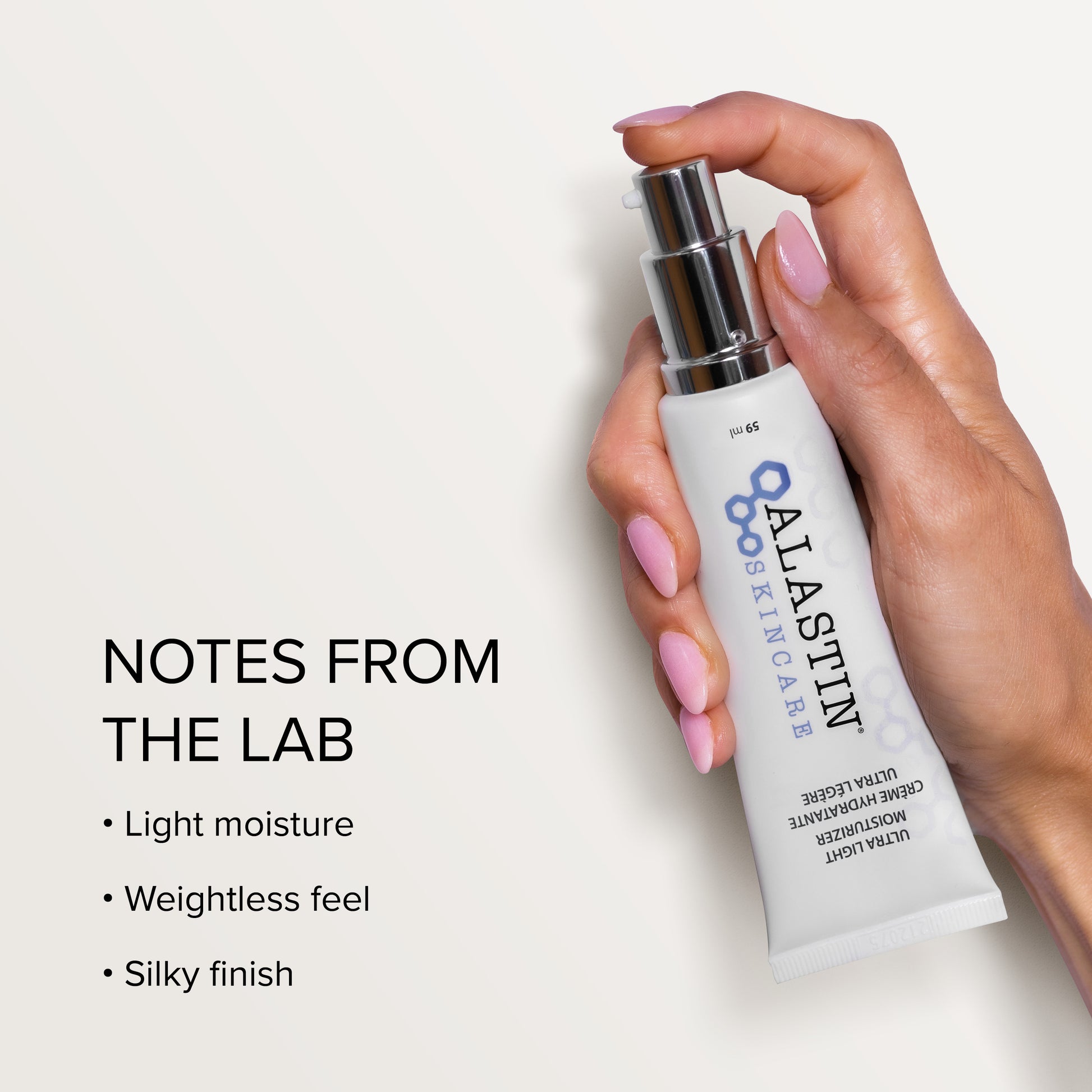 Hand holding a Alastin skincare product with text about product features on a light background